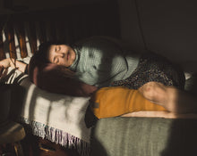 Załaduj obraz do przeglądarki galerii, kobieta która śpi przytulona do różowej poduszki księżycowej a między nogami ma mały żółty wałek wypełniony gryką