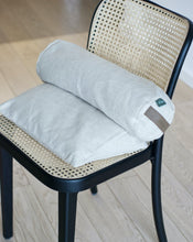 Load image into Gallery viewer, poduszka klinowa i mały wałek z kolekcji be natural w kolorze plażowa biel leżące na krześle
